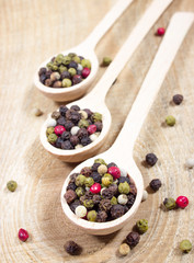 Color pepper on a wooden background.