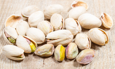 Pistachios on wood background.