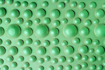 Orthopedic bubble mat for children massage. Green background