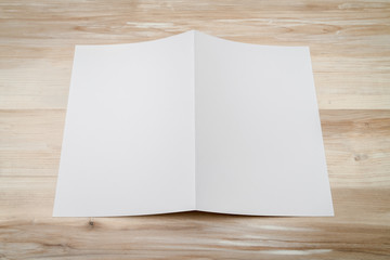 Bifold white template paper on wood texture