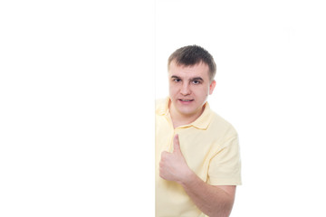 A man in a yellow T-shirt showing blank signboard