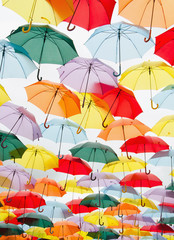 Colorful umbrellas floating on the sky