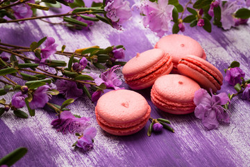Bright macaroons on the wooden background