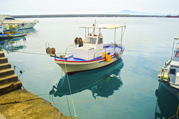 Naklejka na ściany i meble the reflection of a fishing boat on sea