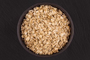 oat flakes on a dark stone board