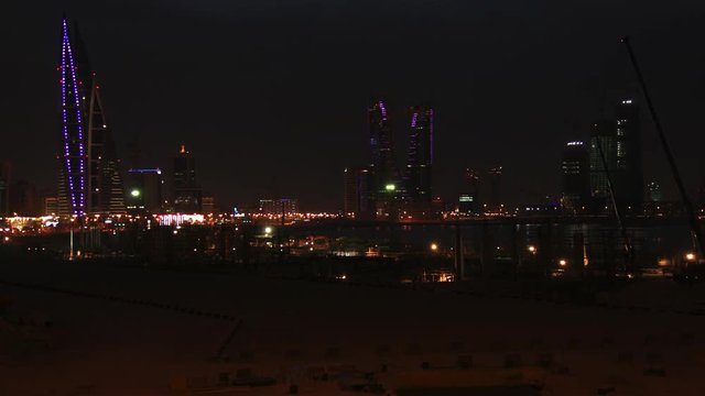 Construction Site in Manama, Bahrain. Timelapse at Dusk. City Skyline on the background. 