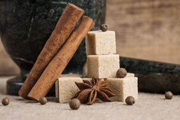 granite mortar sugar star anise allspice cinnamon on the  table