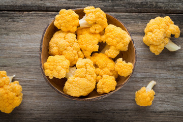 Rainbow of eco cauliflower on the wooden table.