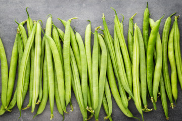 Green beans  on a gray background.