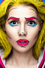 Photo of surprised young woman  with professional comic pop art make-up. Creative beauty style. 