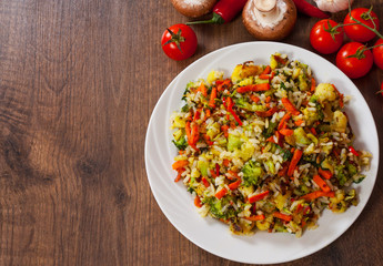 Mixed vegetables with rice in a plate on wooden table