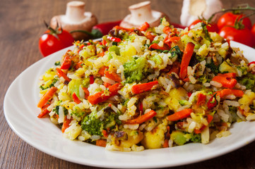 Mixed vegetables with rice in a plate on wooden table