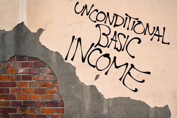 Handwritten graffiti Unconditional Basic Income sprayed on the wall, anarchist aesthetics