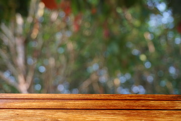 empty wooden table on nature green abstract bokeh in a forest,spring season background 