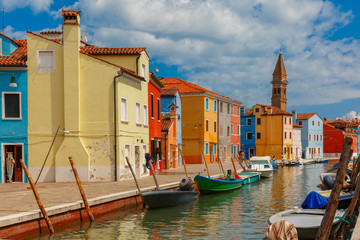 Fototapeta na wymiar Canal with colorful houses and church on the famous island Burano, Venice, Italy