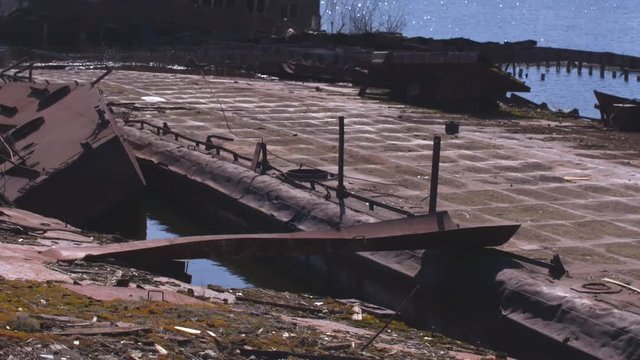 Graveyard of ships on the river.  Many rusty barges and boats in water. Chernobyl zone of alienation