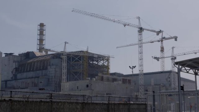 Working cranes near destroyed reactor at Chernobyl nuclear power plant. Time lapse. Chernobyl disaster zone