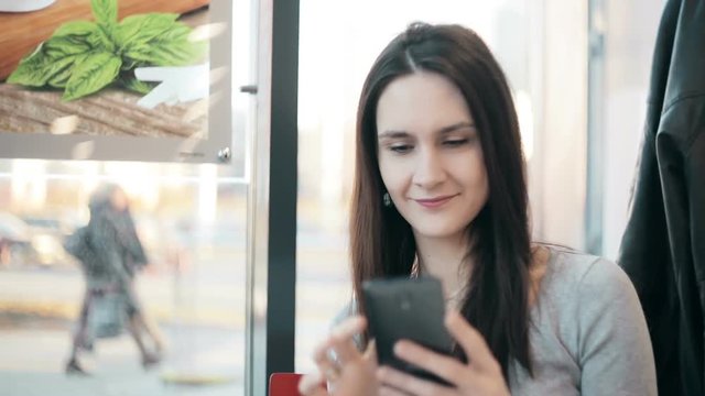 Beautiful woman using  smartphone in cafe. 