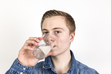 Fototapeta na wymiar portrait of cute teenage boy drinking water