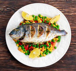 Sea bream baked with herbs and lemon, vegetable mix. 