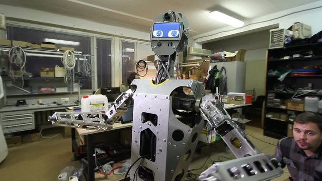 Engineer adjusts the robot