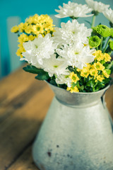 Fresh wild flowers in zinc vase