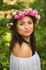 Beautiful young boho woman with rose wreath