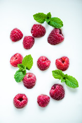 Raspberries and mint on yoghurt background