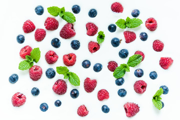 Food background, raspberries and blueberies on yoghurt