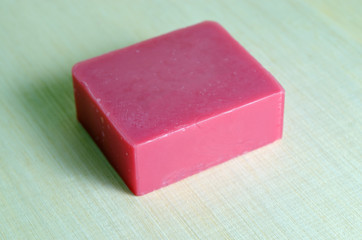 Soap bar flavor with rose ingredient isolated on wooden board ba