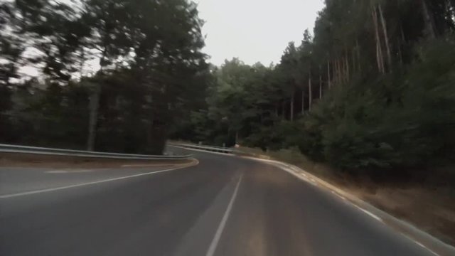 Car moves along a mountain road at night.
