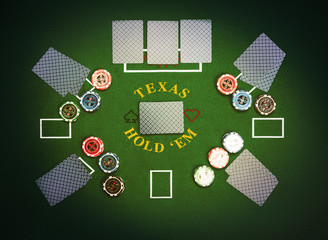 Poker cards and chips lying on green poker cloth. Texas Hold'em.