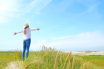 happy woman raising hands, feeling good, north sea island rømø, lakolk, denmark