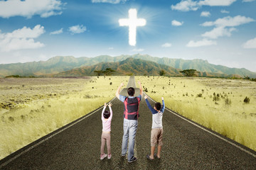 Father follow a cross sign on the road