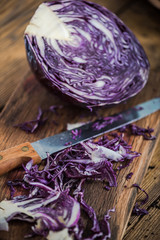 Red cabbage sliced on farmhouse table.