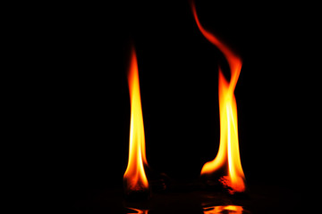 Two high flames on black background