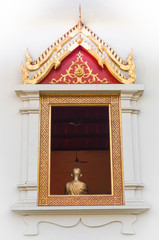 Artistic image of golden buddha inside a window
