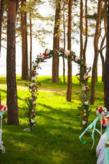wedding arch with flowers in the forest