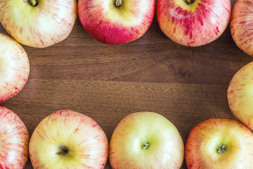 Ripe red apples on wooden background