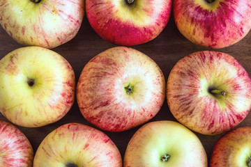 Ripe red apples on wooden background