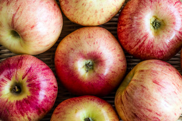 Ripe red apples on wooden background