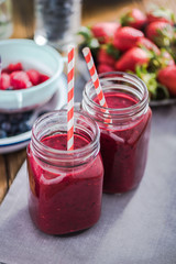 Two jars with berry smoothie