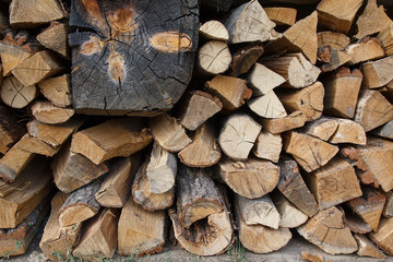 Pile of cut firewood logs. Background and texture