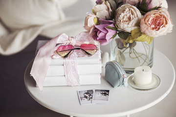 girly stuff - peony roses, heart-shape pink glasses, beautician on white night stand