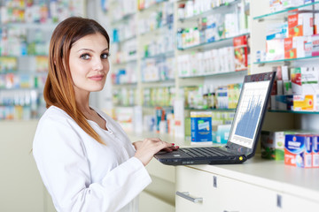Pharmacist checking drugstore stock