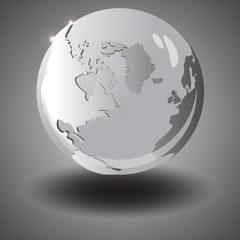 Grey glass globe with the continents in the air. The shadow of t