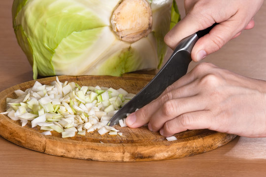 hands chopping cabbage