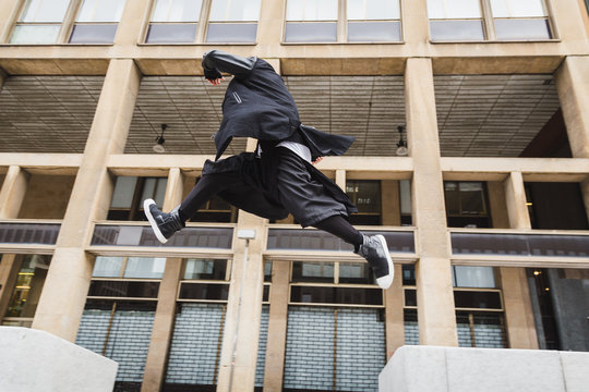Stylish bearded man jumping in the street