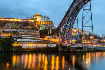 the waterfront of the river Douro and Dom Luis I bridge at night, Porto, Portugal.
