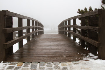 Wooden bridge on the mountain on a snowy day in Madrid, Spain.